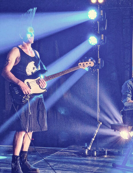 Picture of Nick playing bass on stage in Switzerland