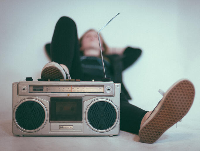 A picture of a teenager lying on the floor listening to music